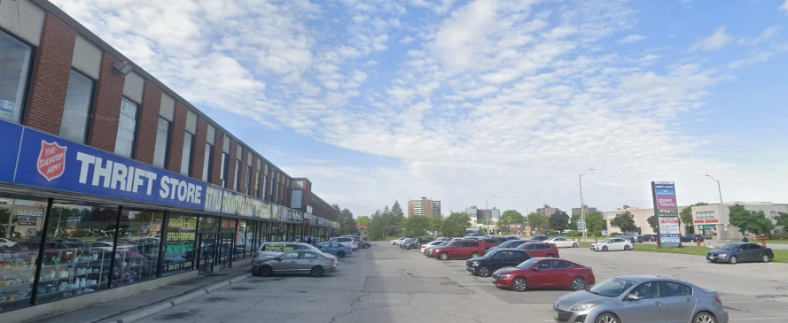 Salvation Army Thrift Store exterior with a blue sign and cars parked in the lot on a sunny day.